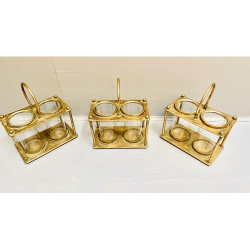 378 - STORM LANTERNS, 33cm x 27cm x 15cm, set of three, gilt metal with a handle to centre. (3)