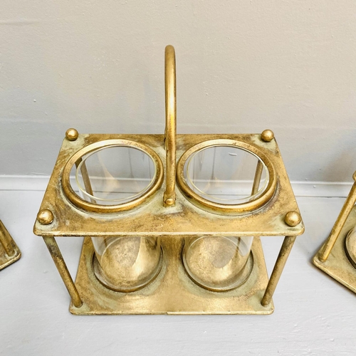 378 - STORM LANTERNS, 33cm x 27cm x 15cm, set of three, gilt metal with a handle to centre. (3)