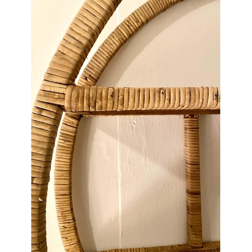 335 - RATTAN WALL MOUNTED DISPLAY SHELF, 80cm diameter, 19cm deep, 1970s Italian style.