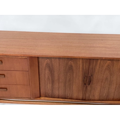 304 - AUSTIN SUITE SIDEBOARD, 1970s teak with three short drawers and pair of tambour doors and tapering s... 