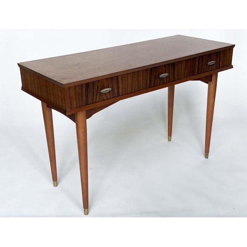 312 - HERBERT E GGIBBS WRITING TABLE, 1960s teak and Indian laurel with three frieze drawers and tapering ... 