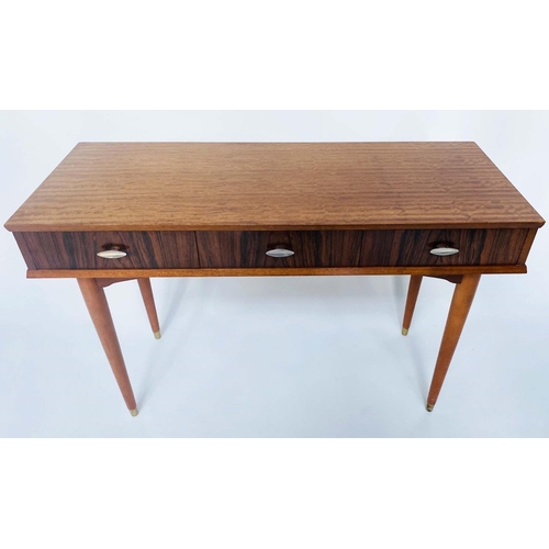 312 - HERBERT E GGIBBS WRITING TABLE, 1960s teak and Indian laurel with three frieze drawers and tapering ... 