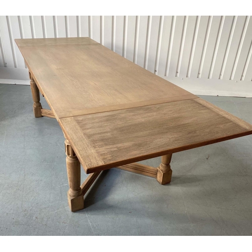 101 - DRAW LEAF EXTENDING DINING TABLE, early 20th century oak, rectangular cleated stretched supports and... 