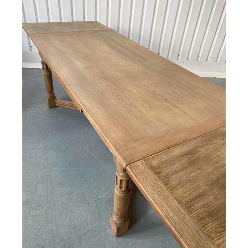 101 - DRAW LEAF EXTENDING DINING TABLE, early 20th century oak, rectangular cleated stretched supports and... 