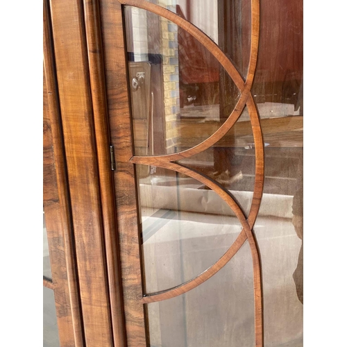 125 - ART DECO DISPLAY CABINET, Art Deco period figured walnut of circular form with two astragal glazed d... 