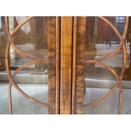 125 - ART DECO DISPLAY CABINET, Art Deco period figured walnut of circular form with two astragal glazed d... 