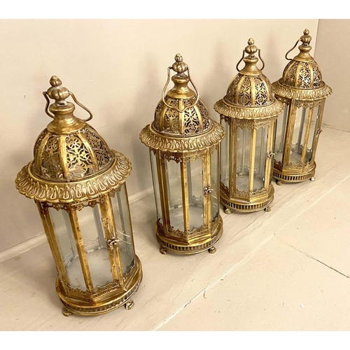 358 - CANDLE LANTERNS, set of four, 61cm H x 21cm D, gilt metal frames and glazed sides, pierced tops. (4)