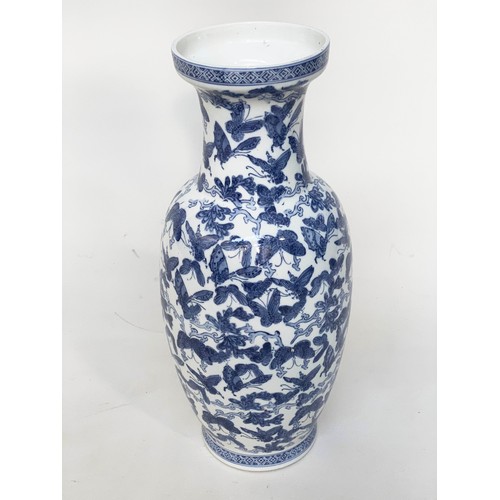 265 - BUTTERFLY VASE, Chinese blue and white ceramic with all over butterfly design, 52cm H.