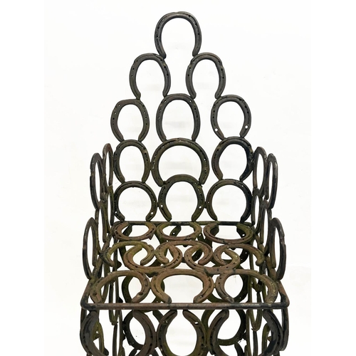 267 - 'HORSESHOE' GARDEN ARMCHAIR AND TABLE, constructed from welded iron horseshoes, chair 110cm H x 41cm... 