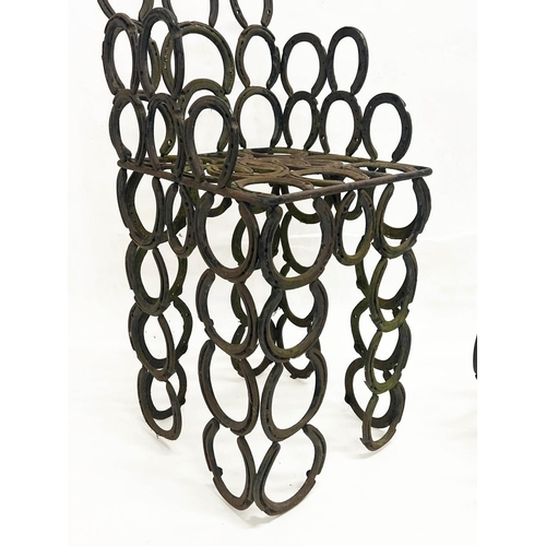 267 - 'HORSESHOE' GARDEN ARMCHAIR AND TABLE, constructed from welded iron horseshoes, chair 110cm H x 41cm... 