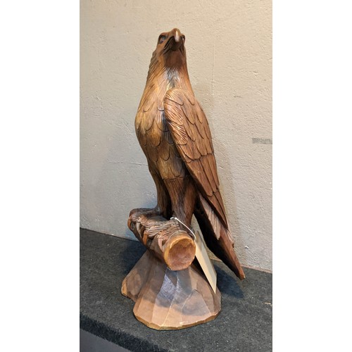 275 - FIGURE OF AN EAGLE, hand carved hardwood, in the form of an eagle perched on a branch, 62cm H x 27cm... 
