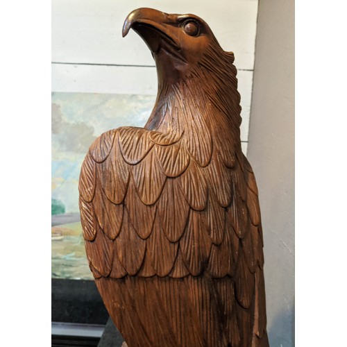 275 - FIGURE OF AN EAGLE, hand carved hardwood, in the form of an eagle perched on a branch, 62cm H x 27cm... 