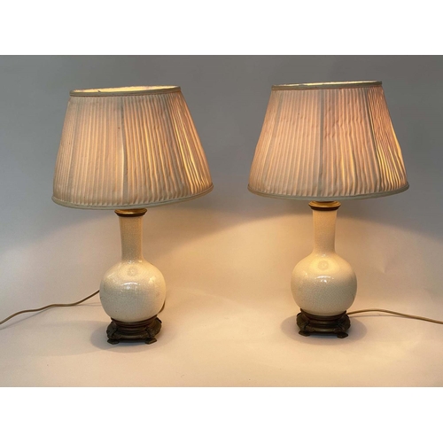 124 - TABLE LAMPS, a pair, cream crackelure ceramic and bronze mounted of gourd form with silk pleated sha... 