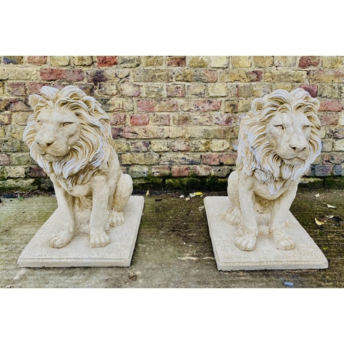 SCULPTURAL LIONS, a pair, composite stone, 67cm H x 42cm W x 54cm D. (2)