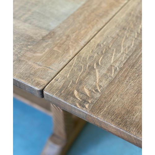 92 - DRAWLEAF EXTENDING DINING TABLE, early 20th century rectangular solid oak and cleated on twin trestl... 