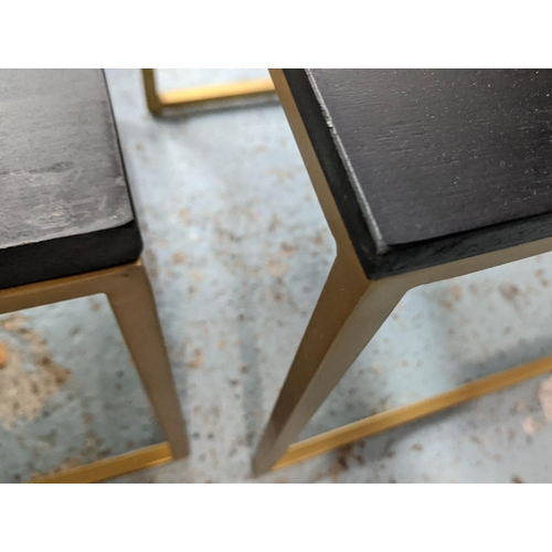 269 - COCKTAIL TABLES, a set of three, 120cm x 39cm x 46cm at largest, ebonised tops, gilt metal bases. (3... 