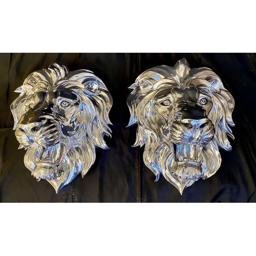 296 - ROARING LION HEADS WALL RELIEF METAL PLAQUES, pair, 49cm x 43cm x 24cm, silvered finish. (2)