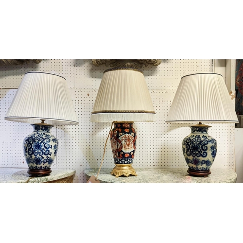 420 - TABLE LAMPS, a pair, blue and white each overall 61cm tall including shades and one other with a gil... 