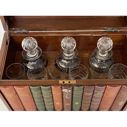 112 - TANTALUS, early 20th century figured walnut and faux book spine with three glass decanters, stamped ... 