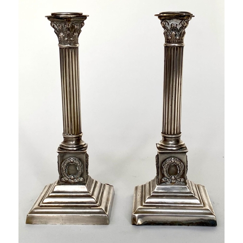 125 - CANDLESTICKS, a pair, early 20th century, Georgian style silvered with fluted columns and stepped pl... 