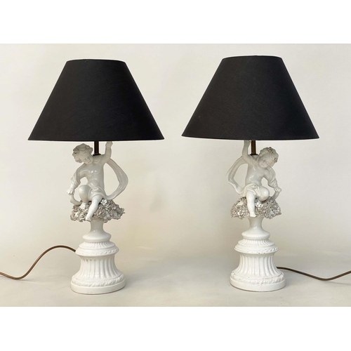 129 - TABLE LAMPS, a pair, 20th century Italian white ceramic, each with seated cupid support (old repairs... 