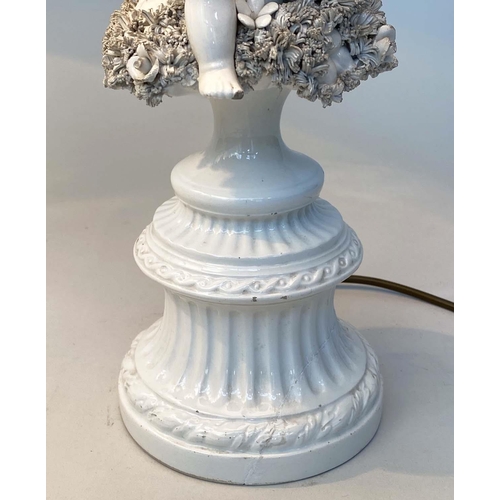 129 - TABLE LAMPS, a pair, 20th century Italian white ceramic, each with seated cupid support (old repairs... 