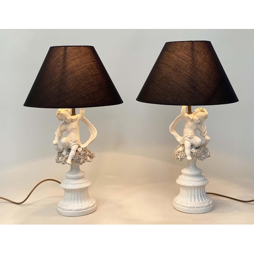 129 - TABLE LAMPS, a pair, 20th century Italian white ceramic, each with seated cupid support (old repairs... 