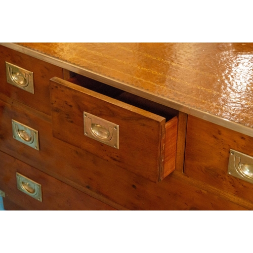 214 - CAMPAIGN STYLE LOW CHEST, 56cm H x 93cm x 62cm, yewwood and brass bound of five drawers with tan lea... 