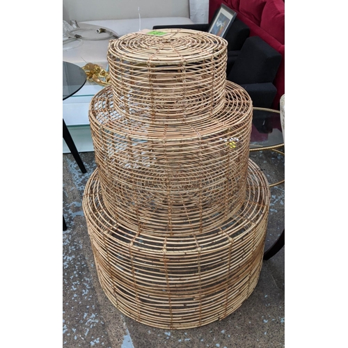 448 - NEST OF DRUM TABLES, a graduated set of three, bamboo, 80cm x 46cm at largest.