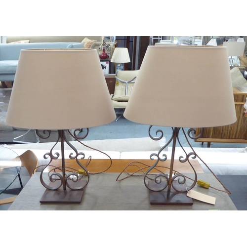 450 - TABLE LAMPS, a pair, 71cm H scrolled metal, each with a shade. (2)