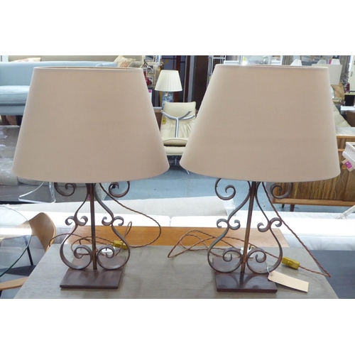 450 - TABLE LAMPS, a pair, 71cm H scrolled metal, each with a shade. (2)