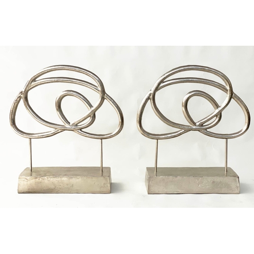 293 - SCULPTURES, a pair, silvered metal on stands, 76cm H x 70cm W. (2)