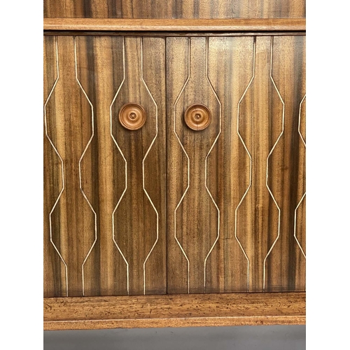 518 - EVEREST SIDEBOARD, 1960's walnut and Indian laurel with incised double helix doors and three frieze ... 