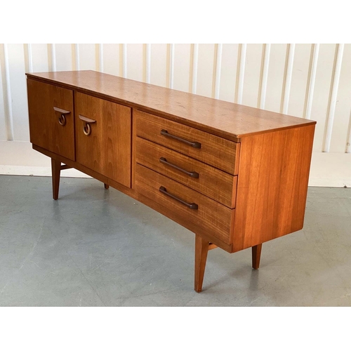 522 - SIDEBOARD, 1970's teak, concave fronted with cupboards and drawers, 184cm x 46cm x 77cm H.