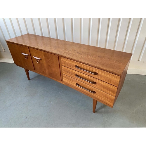 522 - SIDEBOARD, 1970's teak, concave fronted with cupboards and drawers, 184cm x 46cm x 77cm H.