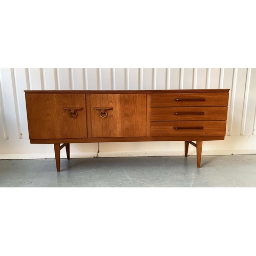 522 - SIDEBOARD, 1970's teak, concave fronted with cupboards and drawers, 184cm x 46cm x 77cm H.