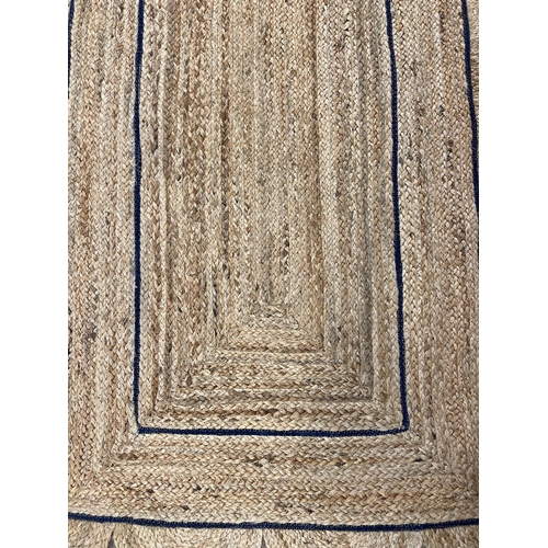 153 - SCALLOPED EDGE JUTE RUNNER, 308cm x 92cm.