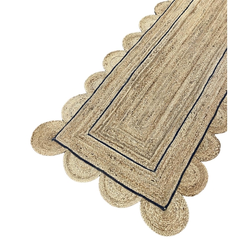 153 - SCALLOPED EDGE JUTE RUNNER, 308cm x 92cm.