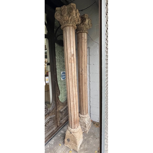 171 - COLUMNS, a pair, Indian carved hardwood with stone bases, approx 247cm H. (2)