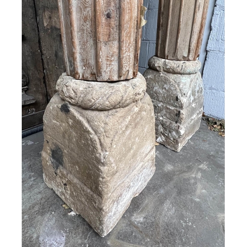 171 - COLUMNS, a pair, Indian carved hardwood with stone bases, approx 247cm H. (2)