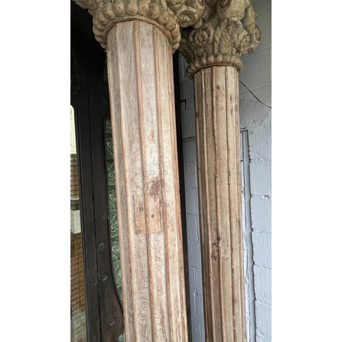 171 - COLUMNS, a pair, Indian carved hardwood with stone bases, approx 247cm H. (2)