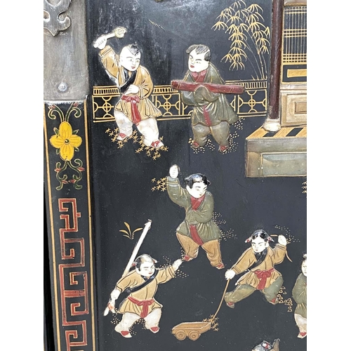 205 - CHINESE CABINETS, a pair, lacquered and gilt Chinoiserie decorated with two doors each enclosing a s... 