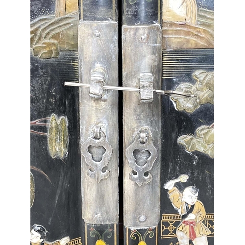 205 - CHINESE CABINETS, a pair, lacquered and gilt Chinoiserie decorated with two doors each enclosing a s... 