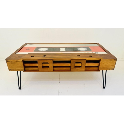 533 - CASSETTE TAPE COCKTAIL TABLE, with storage along one side, on hair pin legs 40cm x 110cm x 60cm.