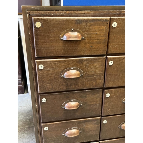 547 - HABERDASHERY COUNTER, oak and bronze framed with glass sides and back with an arrangement of 30 draw... 