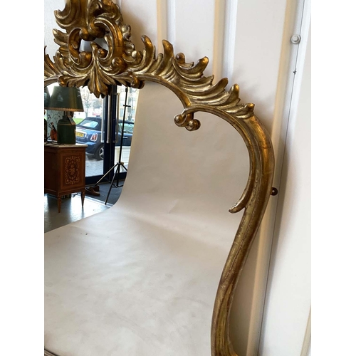 215 - OVERMANTEL MIRROR, 19th century carved giltwood with 'C' scroll crest and foliage floral frame of wa... 