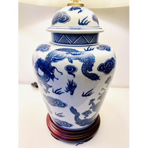 410 - TABLE LAMPS, a pair, Chinese export style blue and white ceramic with dragon design, with shades. (2... 