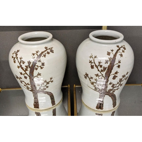 23 - PAOLO MOSCHINO RUSTY BROWN TWIST TREE WITH FLARING RIM JARS, a pair, 43cm H. (2)