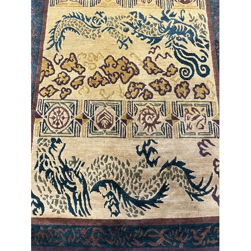 110 - TIBETAN RUGS, two, to include a dragon design rug 185cm x 121cm and one other 185cm x 124cm. (2)