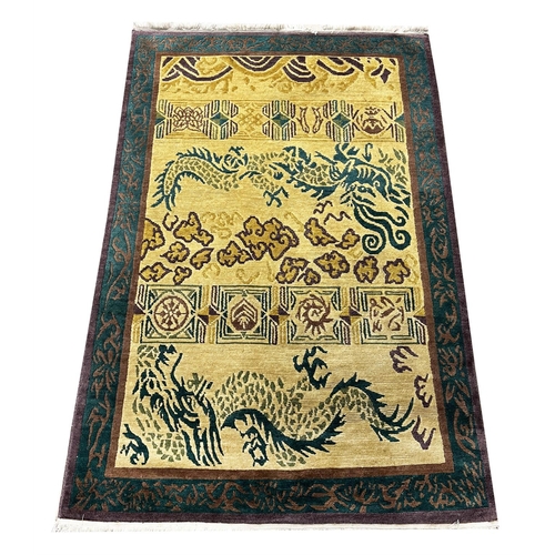 110 - TIBETAN RUGS, two, to include a dragon design rug 185cm x 121cm and one other 185cm x 124cm. (2)